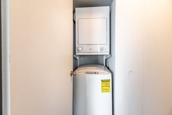A white oven with a yellow sticker on it at BellaVista Apartments in Woodbridge, VA